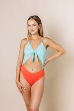 Load image into Gallery viewer, Girl in colour block one piece bikini with cut out. Top is blue and bottom is coral. Front shot