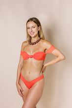 Load image into Gallery viewer, Girl in coral bikini set. Bandeaux top has off-shoulder sleeves. Front shot
